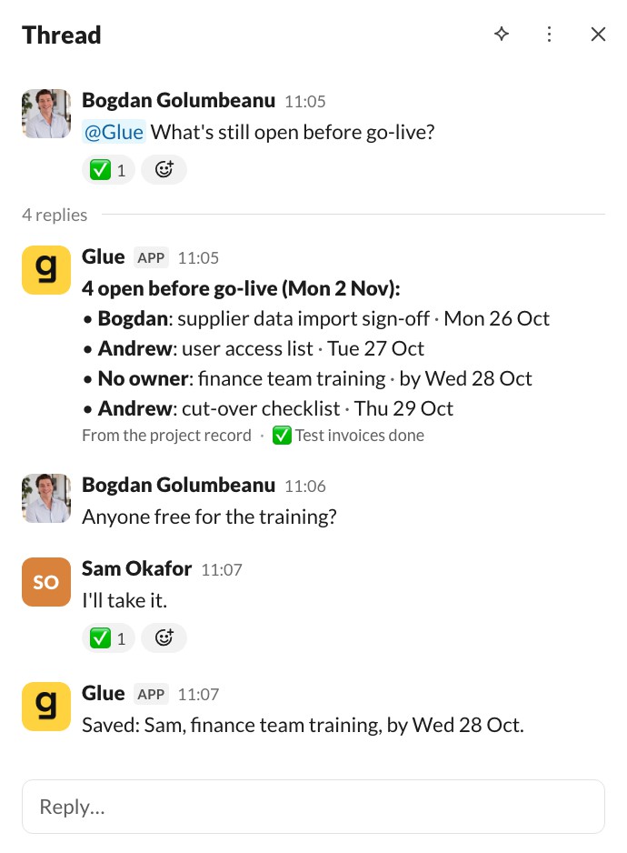 The thread: Glue lists four open items before go-live, one with no owner, finance team training. Bogdan asks who's free; Sam says he'll take it; Glue replies: Saved, Sam, finance team training, by Wed 28 Oct.